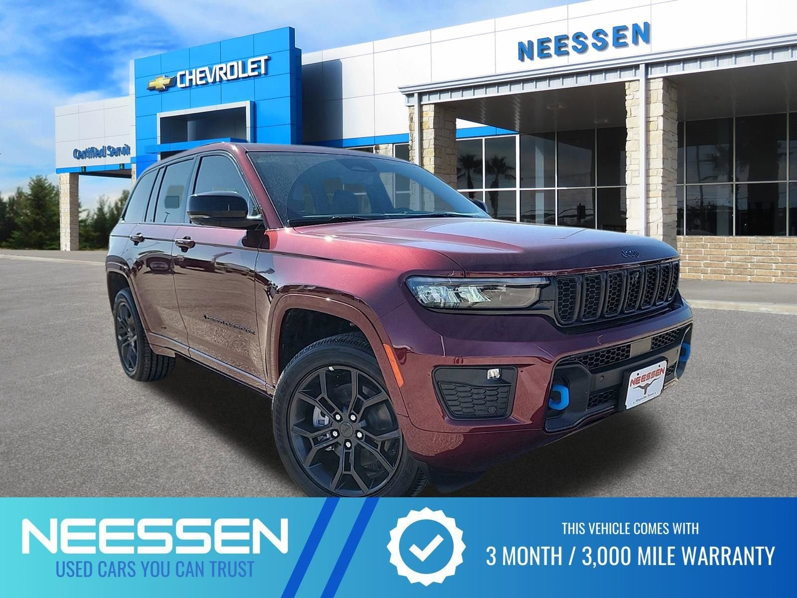 2025 Jeep Grand Cherokee 4xe Anniversary Edition in Velvet Red Pear — front three-quarter view