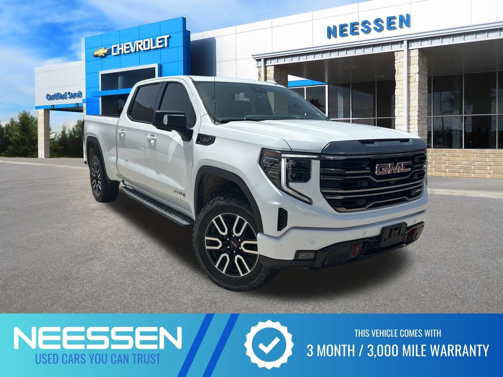 2024 GMC Sierra 1500 AT4 in Summit White — front three-quarter view